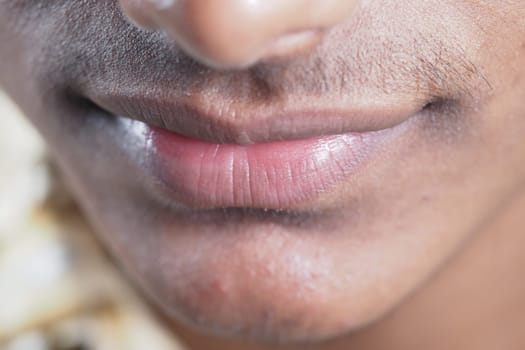 Lips of a young individual are showcased, emphasizing details and texture.