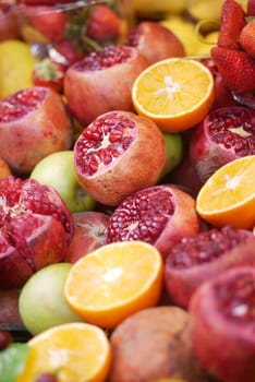 A vibrant assortment of pomegranates, oranges, and apples on display.