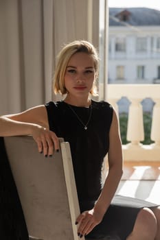 Beautiful blonde woman in black evening dress