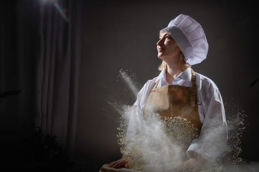 An elderly woman dressed as a cook happily interacts with flour while enjoying a humorous moment in the kitchen.