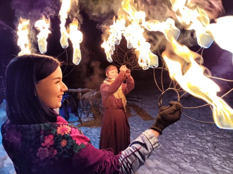 Actors in ethnic costumes perform a vibrant fire show, illuminating the chilly winter night with the spirit of Viking and Slavic traditions.