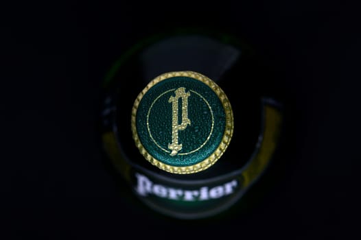 Gaziveren Cyprus -12.03.2025 Water Perrier A green bottle top featuring a unique emblem catches the soft light, accentuating its elegant design and texture.