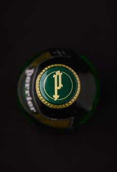 Gaziveren Cyprus -12.03.2025 Water Perrier Captivating view of a bottle cap highlighted by dramatic lighting, revealing its detailed artwork and vibrant colors.