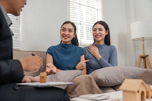 Two clients express their interest in real estate options while consulting with an agent, highlighting a positive engagement.