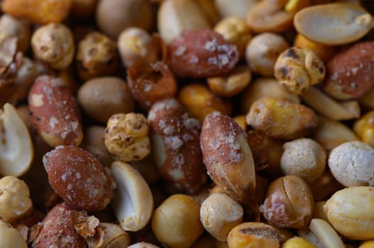 A diverse mix of roasted nuts and seeds offers a tempting treat, showcasing an inviting array of textures and colors.