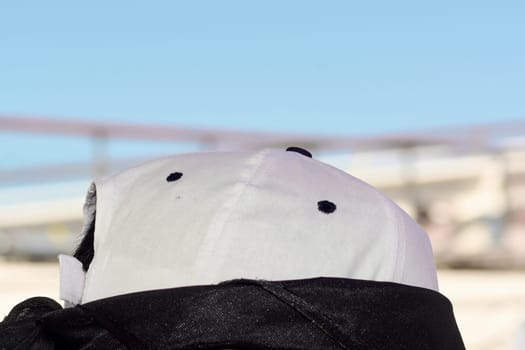 Minimalist design of a casual cap captured outdoors with soft focus on its texture and black ventilation, blending style and comfort.