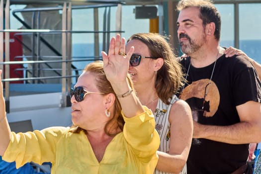 Catania. Italy - March 11, 2025: Energetic crowd interacting during a sunny day activity, capturing lively expressions and a strong sense of camaraderie in the open air.