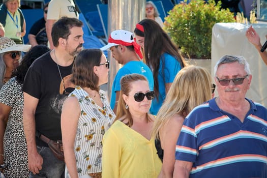 Catania. Italy - March 13, 2025: Energetic group of people gathered at a sunny recreational area, showcasing connection, joy, and harmony during a bright leisure day.