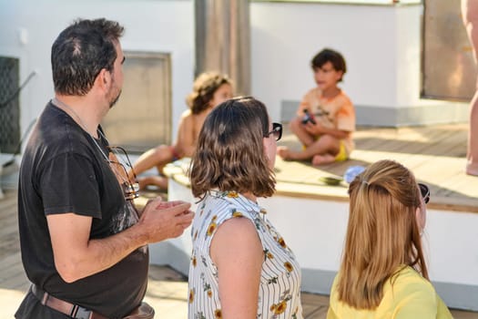 Catania. Italy - March 13, 2025: A cheerful group of friends enjoying a sunny day outdoors, sharing smiles and laughter while engaging in relaxing recreational activities.