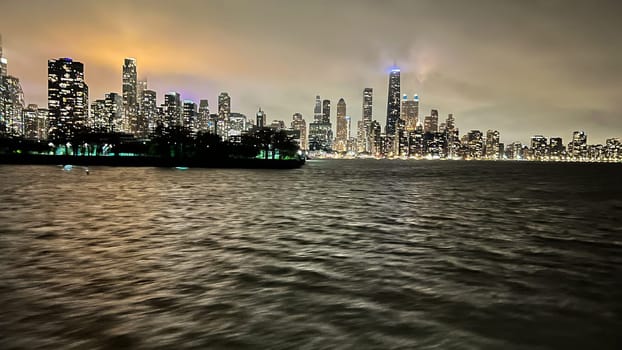Chicago, Illinois, USA-november 7, 2023-An enchanting night-time vista of downtown Chicago as seen from the tranquil waters of the lake.