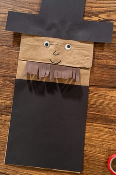 A dedicated teacher brings paper puppets to life, fostering creativity in the classroom through hands-on projects.
