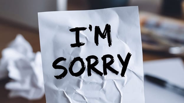 An apology note, handwritten, with smudged ink and torn paper Understanding of Forgiveness and Regret. High quality photo