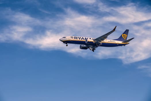 Lisbon, Portugal - Jan 14, 2025: Ryanair Boeing 737 aircraft shot mid-descent with landing gear extended, flying in blue sky with some clouds. Airplane, low-cost airline, budget-friendly, European air travel, weekend getaway, summer vacations