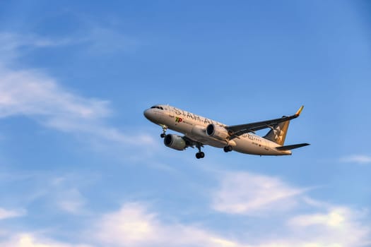 Lisbon, Portugal - Jan 14, 2025: TAP Air Portugal Airbus A320 aircraft in Star Alliance special livery, shot mid-descent with landing gear extended. Airplane, flying, blue sky with some soft clouds, international airline branding,