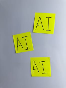 Vertical photo of three sticky notes with the inscription artificial intelligence. AI technologies to help people in the modern world. Development of neural networks in everyday life