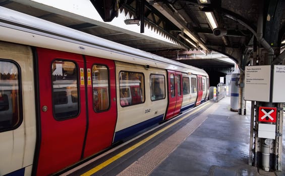 London, UK - September 28 2024: A district line underground train with passengers into view at London Edgware Road Tube Station.