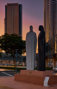 UAE, Dubai, 15 December 2024: The main national monument the sculpture Together made of white Carrara marble, an Arab couple in traditional Emirati clothes, the Syrian sculptor Lutfi Romhain. High quality 4k footage