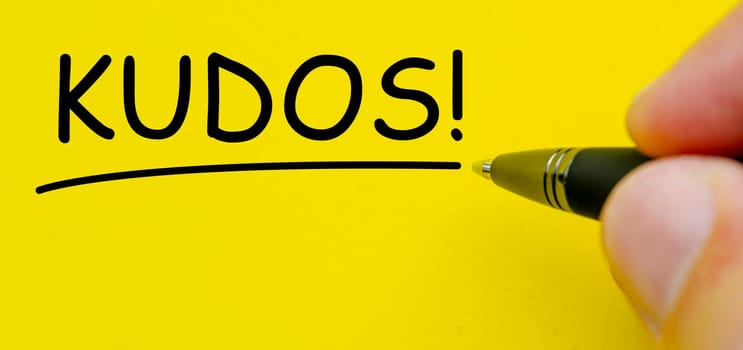 KUDOS text on yellow cover background.