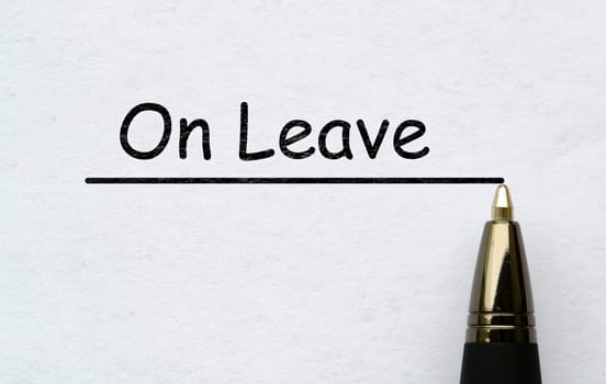 On leave text written on white paper. Vacation concept.
