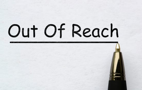 Out of reach text on white paper. Out of office concept.