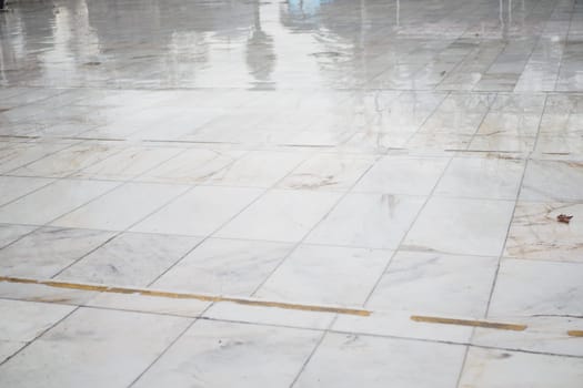 The polished marble floor glistens from recent cleaning, creating reflections.