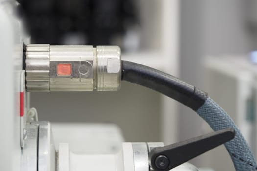 Close-up of a connector in use on industrial machinery during operation.