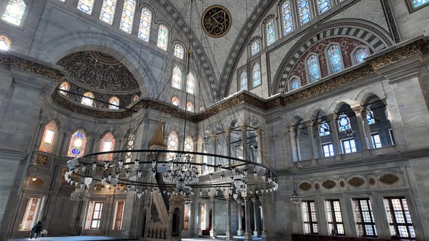 Stunning view of ornate mosque interior highlighting stained glass and arches.