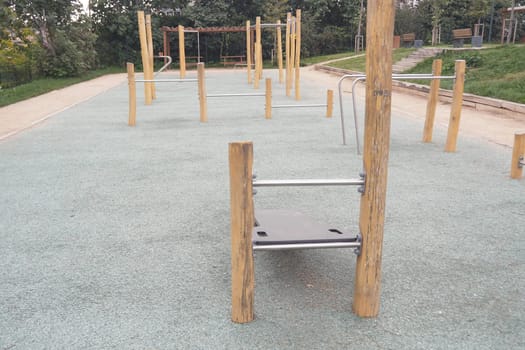 Empty outdoor fitness area features various workout stations for exercise.