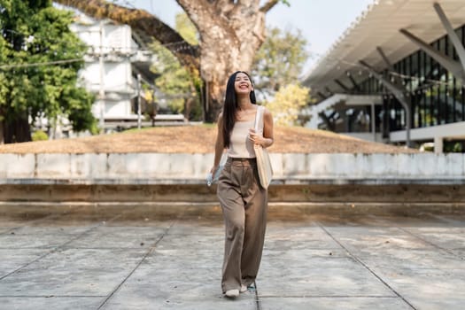 A young woman joyfully walking outdoors with a reusable bag, embodying a sustainable lifestyle.