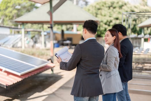 A trio of professionals gathered outdoors to strategize on solar energy systems, illustrating collaboration and a commitment to sustainability in a practical setting.