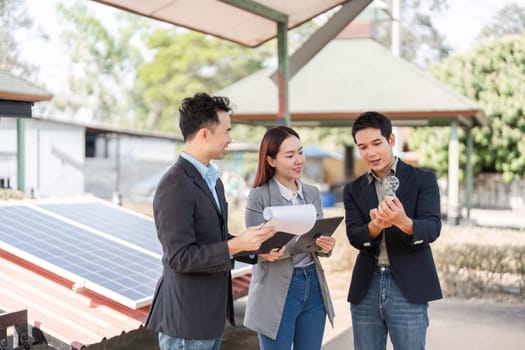 A group of young business professionals reviewing renewable energy options, emphasizing teamwork and sustainability in an outdoor environment as they analyze solar technologies.