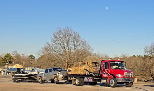 Freight liner Semi-Truck Driving on Open Highway in a Rural Area, CDL Truck America, semi truck and trailer travels along an open road under a blue sky in a rustic rural setting, showcasing commercial transportation, logistics efficiency, and professional trucking