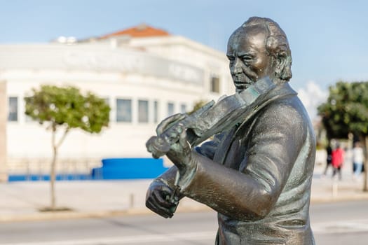 Povoa de Varzim, Porto, Portugal - October 22, 2020: Statue of Fernando Goncalves - Nando by the sculptor Helder de Carvalho at the seaside on an autumn day