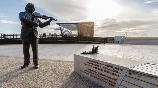 Povoa de Varzim, Porto, Portugal - October 22, 2020: Statue of Fernando Goncalves - Nando by the sculptor Helder de Carvalho at the seaside on an autumn day