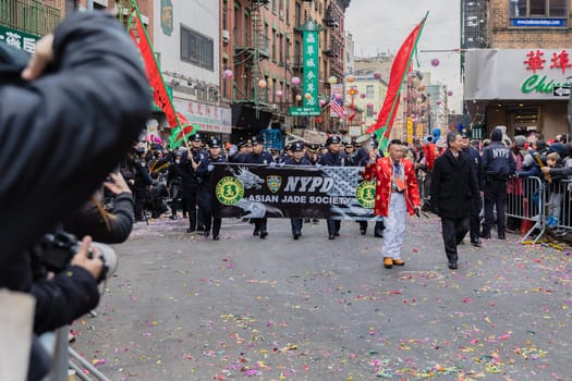 New York, Chinatown, USA - February 12, 2023: NYPD Asian Jade Society parading in front of the public during the Chinatown Chinese New Year 2023 celebration