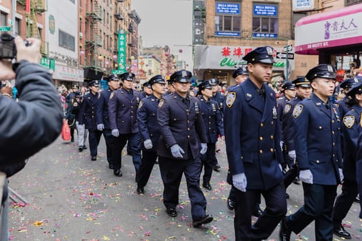 New York, Chinatown, USA - February 12, 2023: NYPD Asian Jade Society parading in front of the public during the Chinatown Chinese New Year 2023 celebration