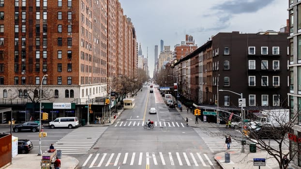 Manhattan, New York, USA - February 16, 2024: View of the Hight Line with its typical buildings seen from above as people visit on a gray winter day