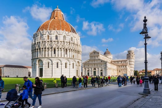 Pisa, Tuscany, Italy - January 04, 2024: Architectural detail of Pisa Cathedral "Catterdrale di Pisa" where tourists are walking on a beautiful winter day