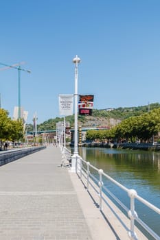 Bilbao, Spain - July 19, 2016: Banks of the Nervion River and its surroundings in the city center on a hot summer day