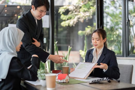 A focused team works together to explore innovative sustainable practices, highlighting their commitment to environmental responsibility in business.