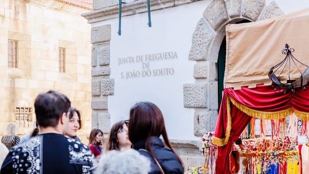 Braga, Portugal - May 26, 2024: Street atmosphere in the historic city center during the Braga Romana event with visitors walking around on a spring day