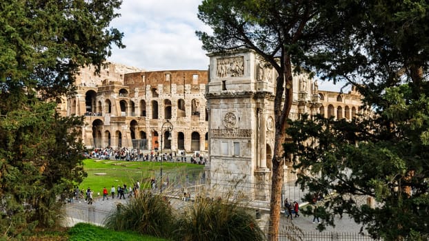 Rome, Italy - December 27, 2023: view of the Coliseum of Rome visited by tourists in the historic city center on a winter day