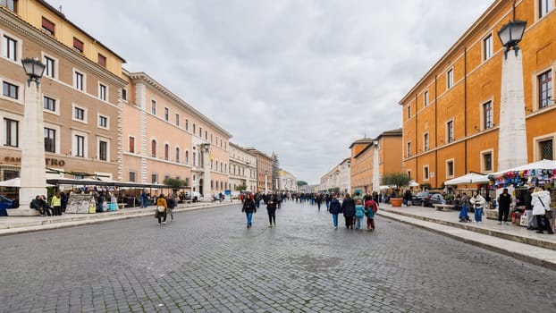 Vatican City, Vatican - December 29, 2023: View of Conciliation Street in front of St. Peter's Basilica in San Pietro Square (Saint Peter's Square) where tourists are walking on a winter day