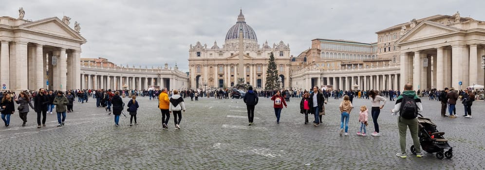 Vatican City, Vatican - December 29, 2023: Street atmosphere in San Pietro Square (Saint Peter's Square) where tourists are walking on a winter day in bad weather