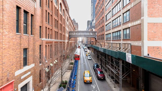 Manhattan, New York, USA - February 16, 2024: View of the Hight Line with its typical buildings seen from above as people visit on a gray winter day