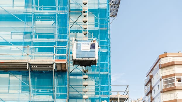 Povoa de Varzim, Porto, Portugal - October 22, 2020: full height scaffolding of seaside building under renovation on an autumn day