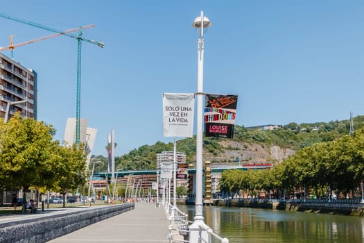 Bilbao, Spain - July 19, 2016: Banks of the Nervion River and its surroundings in the city center on a hot summer day