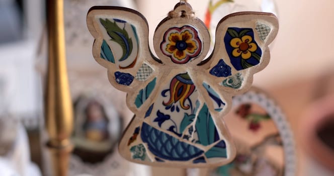 A beautifully crafted mosaic angel designed for Easter, showcasing intricate patterns and bright colors.