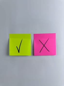 Vertical photo with answer choice concept. True or False with sticky notes. Tick marks the correct answer, Cross marks the incorrect option. Choosing the right answer