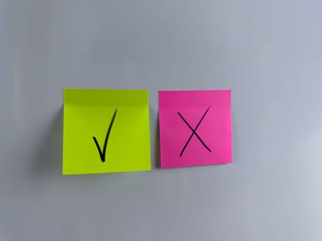 Green check mark and red cross on sticky note, correct and incorrect icons, accept and reject symbols, signs for vote, choose the correct answer and mark it